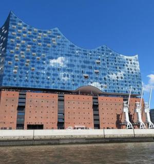 a large building with a glass facade next to the water