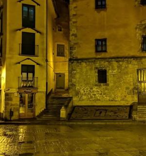 an empty city street at night with buildings