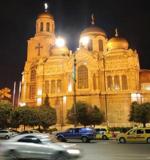 一座大教堂，前面停满了汽车