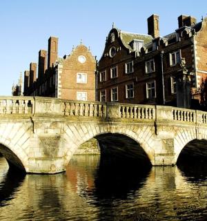 a bridge over a river in front of a building