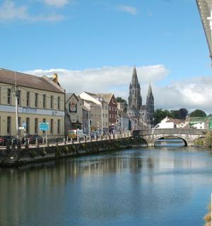 a bridge over a river in a town with a church