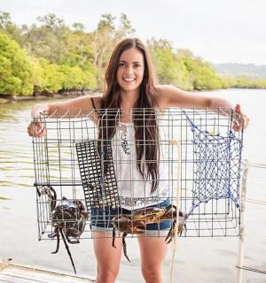 a woman is holding a shopping basket on a boat