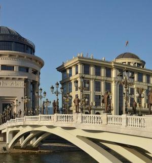 a bridge over a river in front of a building