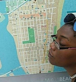 a woman wearing glasses looking at a map