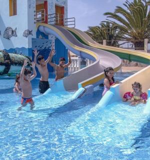 a group of children playing in a water park