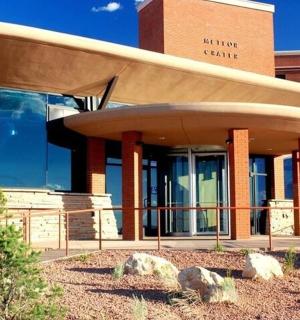 a building with a curved roof in front