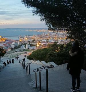 a couple taking a picture of a city at dusk