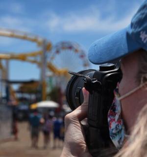 a woman taking a picture of a carnival with a camera