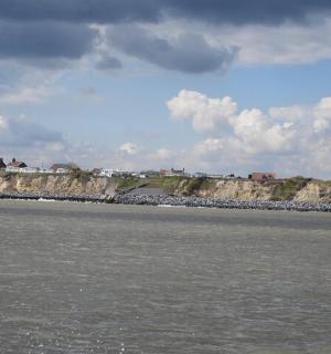 a view of a body of water with a rocky shore