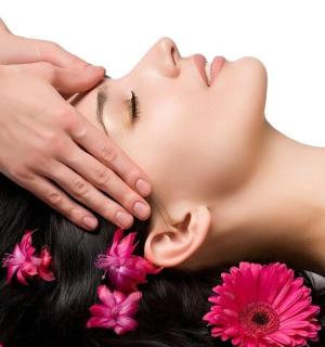 a woman with her hands on her face with flowers