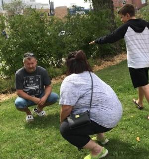 a group of people standing in the grass