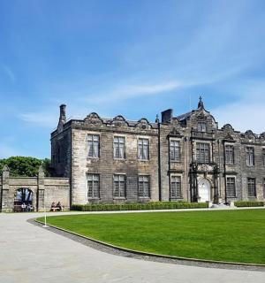 a large building with a green lawn in front of it