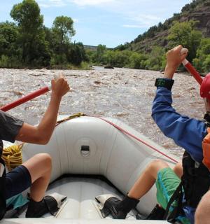 eine Gruppe von Menschen in einem Floß auf einem Fluss