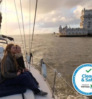 two women sitting on a boat in the water with big ben