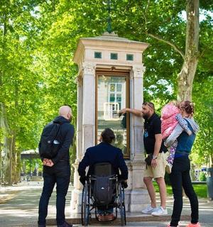a group of people standing around a statue in a park