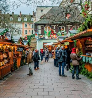 a group of people walking through a christmas market