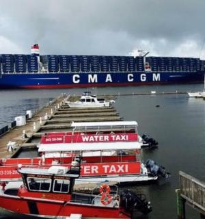 two boats docked at a dock with a cruise ship