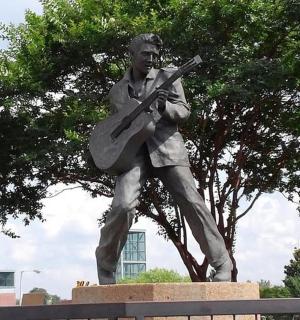 a statue of a man holding a guitar
