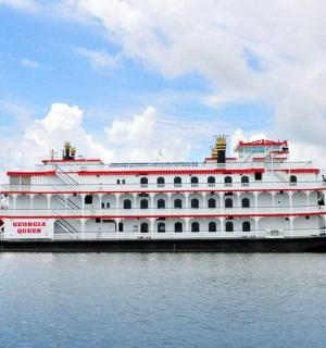 a large white cruise ship on the water