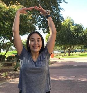 žena stojící s rukama ve vzduchu