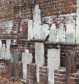 a brick wall with a bunch of graves