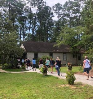 a group of people walking in front of a house