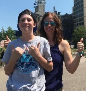a woman giving the thumbs up sign next to a girl