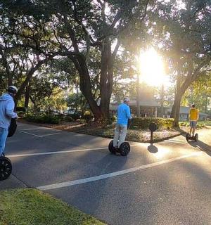 a group of people riding on segways in a street