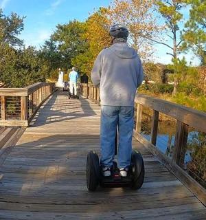 a man riding a segway on a bridge