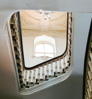 a spiral staircase with a mirror on the ceiling