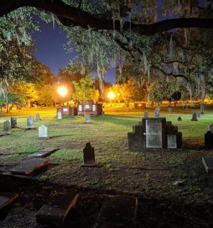 a cemetery at night with a bunch of graves