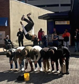 a man is jumping over a group of sheep