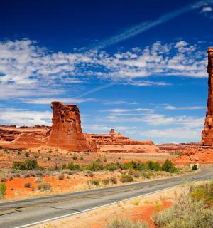 a road in the desert with red rocks