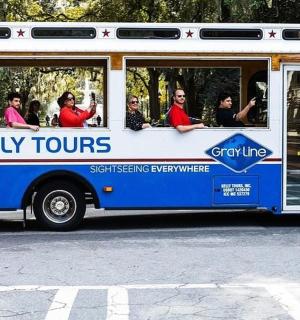 a shuttle bus with people sitting in the window