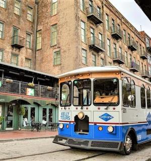 a blue and white bus parked on a city street