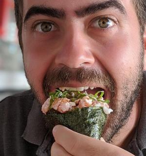 一名男子张着嘴吃三明治