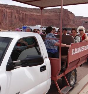 a group of people riding in the back of a truck