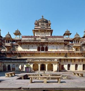a large building with benches in front of it