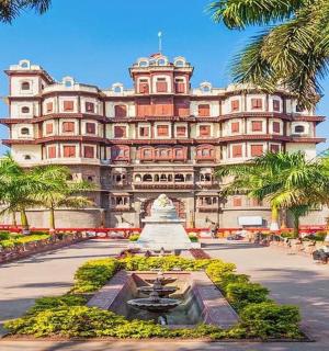 a large building with palm trees in front of it