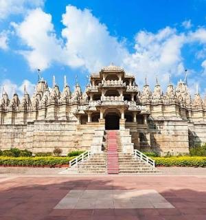 a large white building with stairs in front of it
