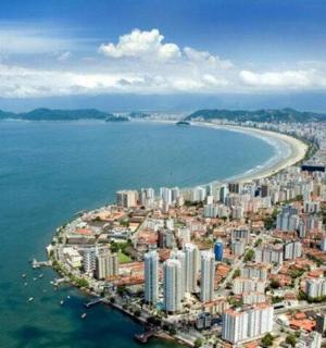 an aerial view of a city next to the ocean