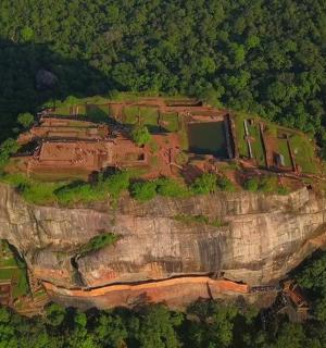 a house on top of a cliff on a mountain