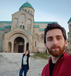 a man and a woman standing in front of a building