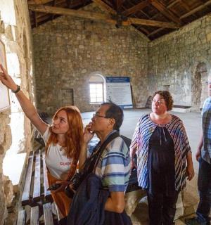 a group of people looking at a painting on a wall