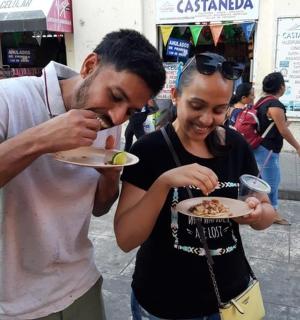 a man feeding a woman a plate of food