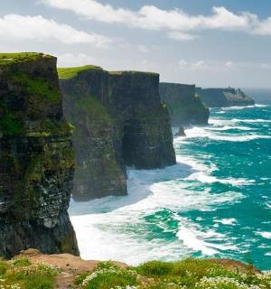 a view of the ocean with a large cliff