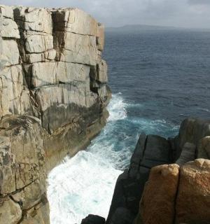 a view of the ocean from a rocky cliff