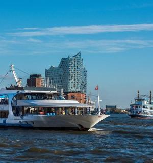 two boats on the water with buildings in the background