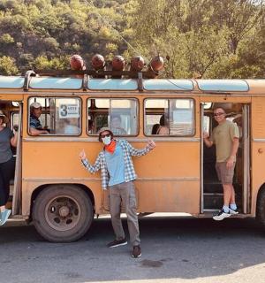 a group of people standing inside of an old bus