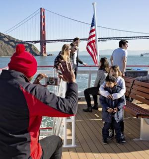 a man taking a picture of a group of people on a boat